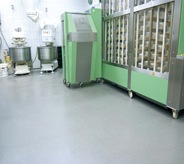 Commercial mixers sit on top of bakery flooring.